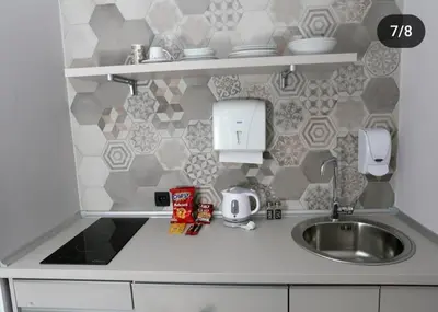a kitchen counter top with a sink and a sink at Apartmani Prag in Banja Luka