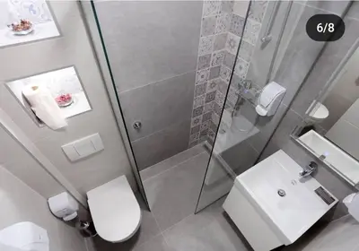 a bathroom with a shower and a toilet and a sink at Apartmani Prag in Banja Luka