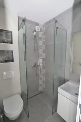 a bathroom with a shower with a toilet and a sink at Apartmani Prag in Banja Luka