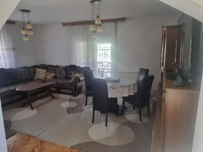 a living room with a table and chairs and a couch at Villa Alejna in Gradačac