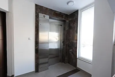 a walk in shower in a room with a window at Apartman Platinum in Banja Luka