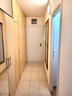 a hallway with a white door and a tile floor at Apartman Borik in Banja Luka