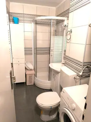 a bathroom with a toilet and a shower and a washing machine at Apartman Borik in Banja Luka