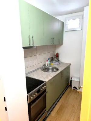 a kitchen with green cabinets and a sink at Apartman Borik in Banja Luka