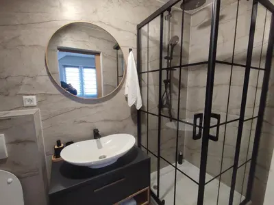 a bathroom with a sink and a mirror at Studio apartman Čolić - Kupres in Kupres