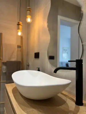 a white bowl on a counter in a bathroom at Home Away From Home 2 in Jajce