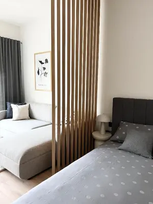 a bedroom with two beds and a wooden partition at Home Away From Home 2 in Jajce