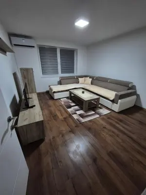 a living room with a couch and a table at Zevs Apartman in Prijedor