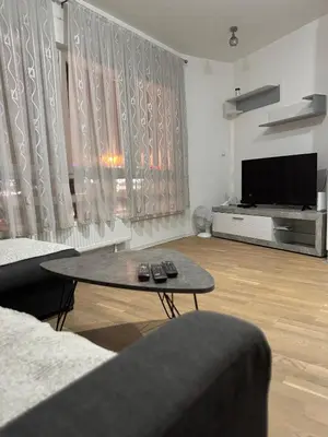 a living room with a coffee table and a television at Stay inn Tuzla in Tuzla