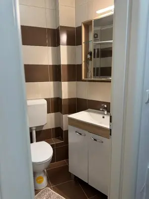 a bathroom with a toilet and a sink at Stay inn Tuzla in Tuzla