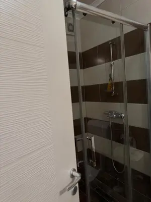 a bathroom with a shower with a glass door at Stay inn Tuzla in Tuzla
