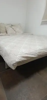 a bed with white sheets and pillows on it at Stan Banja Luka in Banja Luka