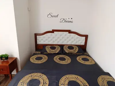 a bedroom with a bed with a black and gold bedspread at Apartman Gold&Black Banja Luka in Banja Luka