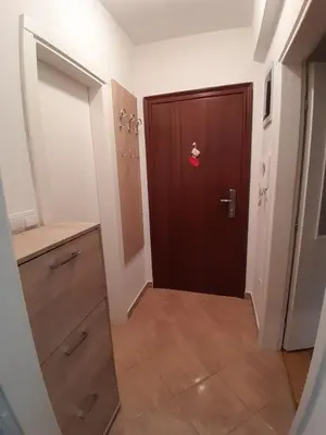 a hallway with a door with a red sticker on it at Apartman Gold&Black Banja Luka in Banja Luka