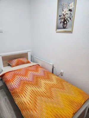 a bed in a bedroom with a painting on the wall at Apartmani Una Lux in Spilja