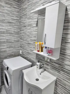 a bathroom with a white toilet and a sink at Apartmani Una Lux in Spilja