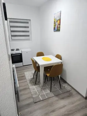 a white table and chairs in a small kitchen at Apartmani Una Lux in Spilja