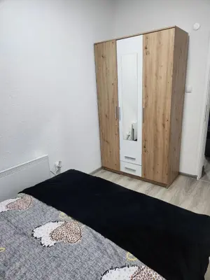 a bedroom with a large mirror and a bed at Apartmani Una Lux in Spilja