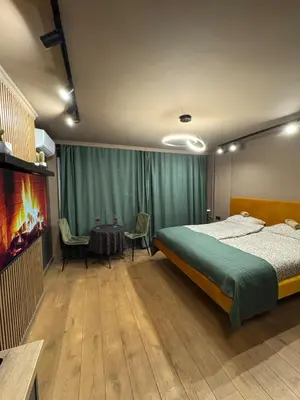 a bedroom with a bed and a table and chairs at Apartman Iris in Banja Luka