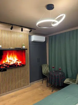 a living room with a fireplace in the wall at Apartman Iris in Banja Luka