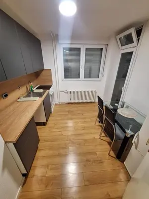 a kitchen with a counter and a table and chairs at Empress in Banja Luka