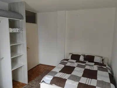 a bedroom with a bed and a book shelf at Empress in Banja Luka