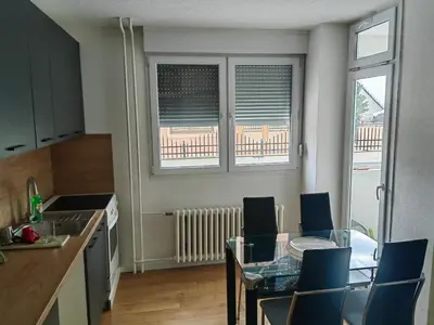 a kitchen with a table and chairs and a dining room at Empress in Banja Luka