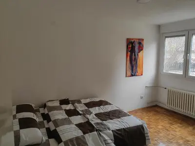 a bedroom with a bed and a painting on the wall at Empress in Banja Luka