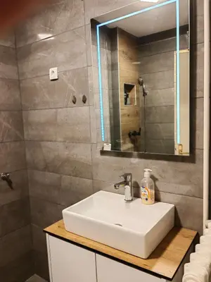 a bathroom with a white sink and a mirror at Empress in Banja Luka