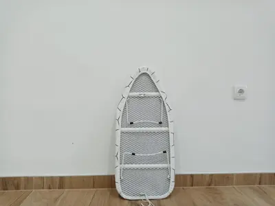 a white surfboard leaning against a white wall at Sava & Room in Prijedor