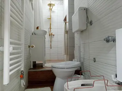 a white bathroom with a toilet and a sink at Sava & Room in Prijedor