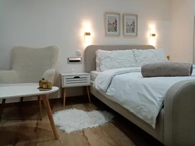 a bedroom with a bed and a table and a chair at Sava & Room in Prijedor