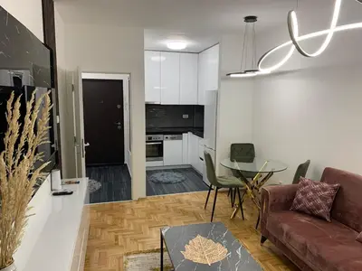 a living room with a couch and a table at Zlatni San apartman 2 in Banja Luka
