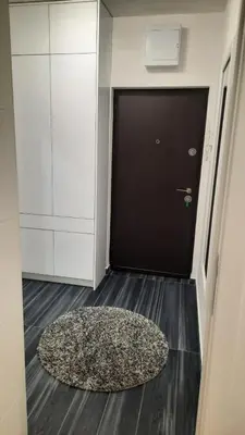 a rug on the floor in front of a door at Zlatni San apartman 2 in Banja Luka