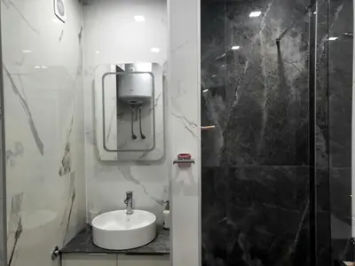 a white bathroom with a sink and a shower at Ellie in Banja Luka