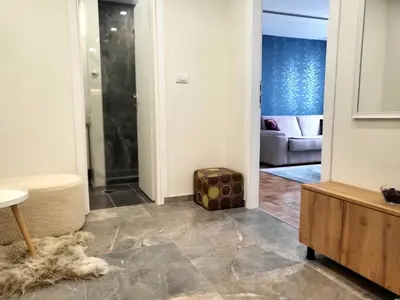 a living room with a glass door leading into a living room at Ellie in Banja Luka