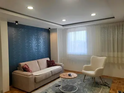 a living room with a couch and a chair at Ellie in Banja Luka