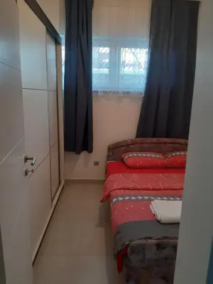 a small room with two beds and a window at Fest in Banja Luka