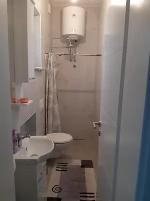a white bathroom with a sink and a toilet at Fest in Banja Luka