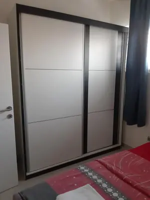 a sliding glass door with a mirror in a bedroom at Fest in Banja Luka