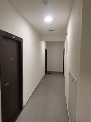 an empty hallway with a black door and white walls at Apartman Stanko in Železnička Stanica Banja Luka Predgrađe