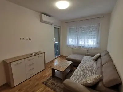 a living room with a couch and a table at Apartman Stanko in Železnička Stanica Banja Luka Predgrađe