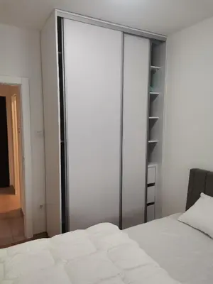 a bedroom with sliding glass doors and a bed at Apartman Stanko in Železnička Stanica Banja Luka Predgrađe