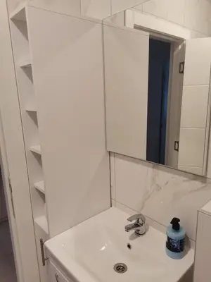 a white bathroom with a sink and a mirror at Apartman Stanko in Železnička Stanica Banja Luka Predgrađe