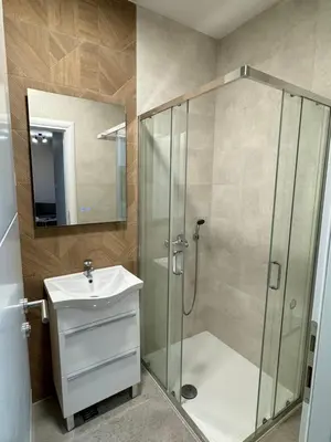 a bathroom with a shower and a sink at Banja Luka Comfort - Wifi & Parking in Banja Luka
