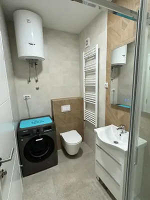 a small bathroom with a washing machine and a sink at Banja Luka Comfort - Wifi & Parking in Banja Luka