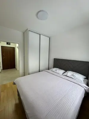 a bedroom with a large white bed with two pillows at Banja Luka Comfort - Wifi & Parking in Banja Luka