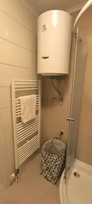 a bathroom with a toilet and a sink and a towel at City apartman Modrica in Modriča
