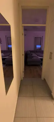 a room with two beds and a mirror on the wall at City apartman Modrica in Modriča