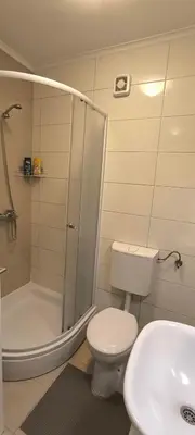 a bathroom with a shower and a toilet and a sink at City apartman Modrica in Modriča